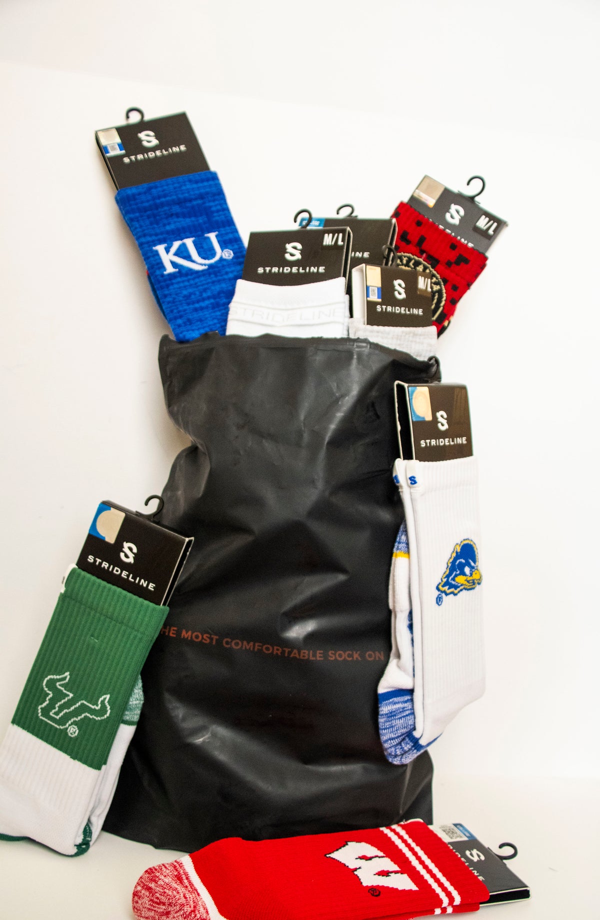 Mystery Bag with assorted colorful socks from various teams, featuring blue, red, and green designs.