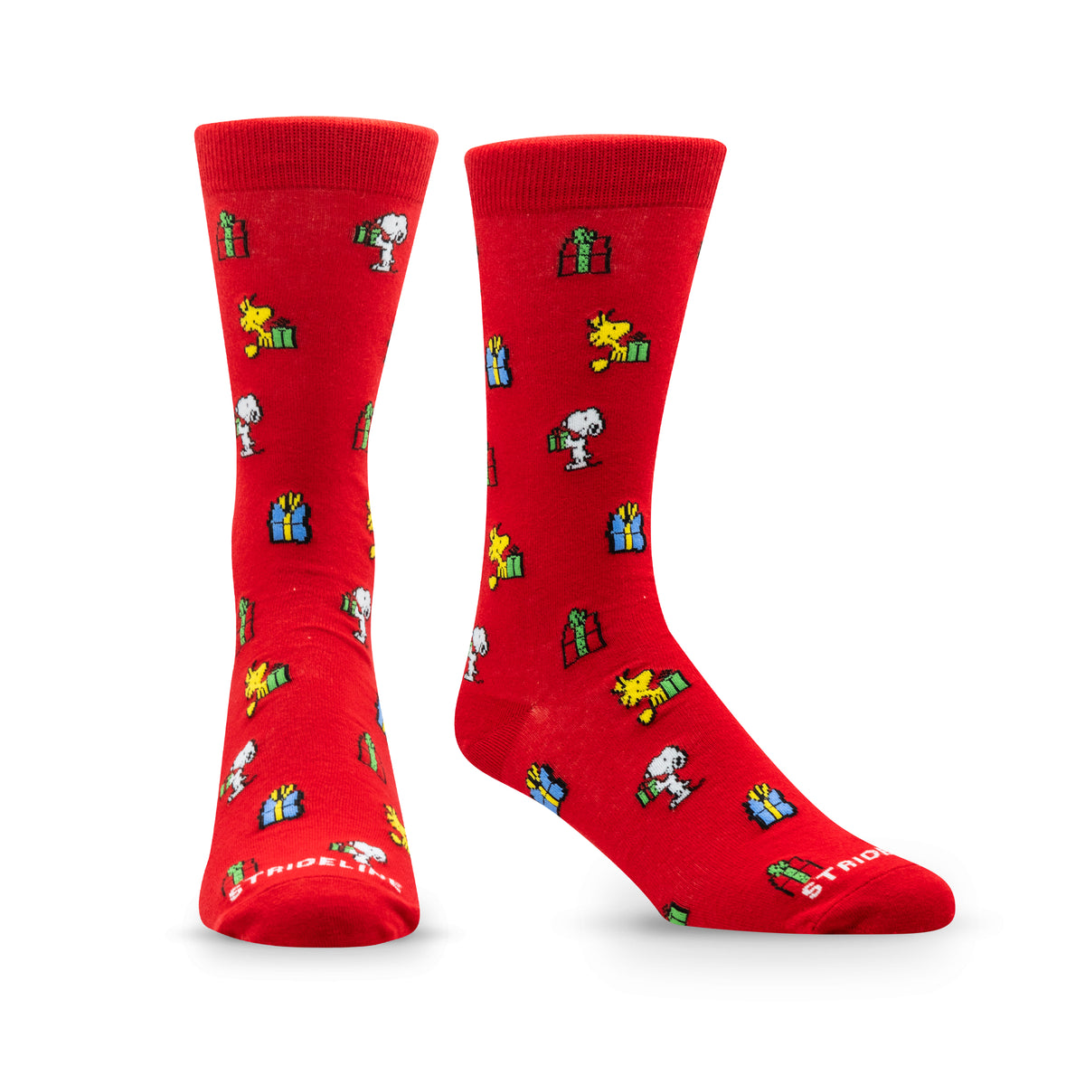 Red socks featuring Snoopy and friends with gifts and presents in a festive pattern.
