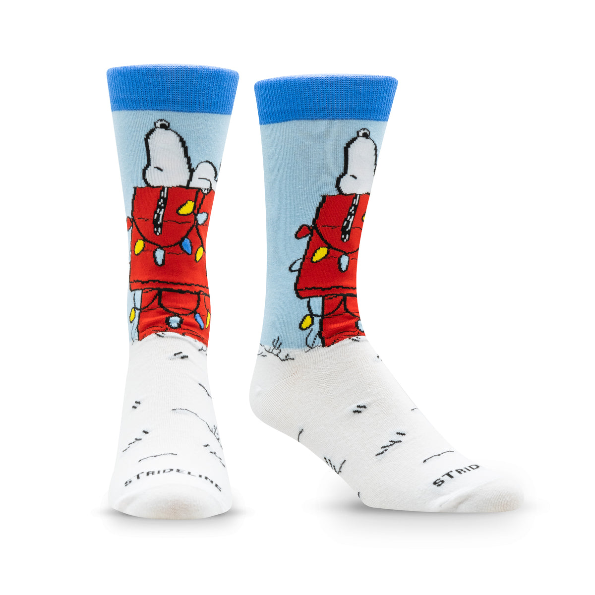 Colorful socks featuring a cartoon character decorating a Christmas tree with lights, set against a snowy background.